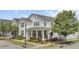 Beautiful two-story home showcasing a well-maintained lawn, charming front porch, and an inviting orange door at 351 Gnarly Oak Ln, Summerville, SC 29485