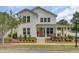 Charming two-story home with a welcoming front porch, manicured landscaping, and a vibrant orange front door at 351 Gnarly Oak Ln, Summerville, SC 29485