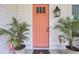 Inviting front entry featuring a vibrant orange door, elegant lantern, and decorative potted plants at 351 Gnarly Oak Ln, Summerville, SC 29485