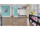 Hallway with a bright blue accent wall, a built-in shoe rack, and a yellow door at 351 Gnarly Oak Ln, Summerville, SC 29485