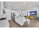Open-concept kitchen and living area with white cabinetry, stainless appliances, a large island, and hardwood floors at 351 Gnarly Oak Ln, Summerville, SC 29485