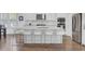Modern kitchen with a large island, stainless steel appliances, and white cabinetry at 351 Gnarly Oak Ln, Summerville, SC 29485