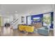 Inviting living room with wood floors, stylish seating, and a striking blue accent wall at 351 Gnarly Oak Ln, Summerville, SC 29485