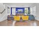 Cozy living space with neutral furnishings, a television, and an open staircase at 351 Gnarly Oak Ln, Summerville, SC 29485