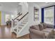 Comfortable living room with stairs and views to the yard and other rooms at 351 Gnarly Oak Ln, Summerville, SC 29485