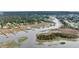 Picturesque aerial view of a coastal waterway featuring docks, lush marshland, and waterfront properties at 3555 Colonel Vanderhorst Cir, Mount Pleasant, SC 29466