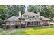 Beautiful brick home features a large screened porch, deck, and pristine lawn with mature trees at 3555 Colonel Vanderhorst Cir, Mount Pleasant, SC 29466