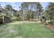 Spacious, well-maintained backyard with a cozy fire pit area and mature trees providing ample shade and privacy at 3555 Colonel Vanderhorst Cir, Mount Pleasant, SC 29466