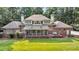 Sprawling brick home boasts a large screened porch, deck, and pristine lawn enveloped by lush trees at 3555 Colonel Vanderhorst Cir, Mount Pleasant, SC 29466