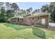 Charming brick home with a screened porch, wooden deck, and beautifully landscaped backyard with mature trees at 3555 Colonel Vanderhorst Cir, Mount Pleasant, SC 29466