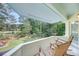 Inviting balcony with rocking chairs and a view of manicured lawn with mature trees at 3555 Colonel Vanderhorst Cir, Mount Pleasant, SC 29466