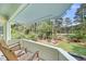 Relaxing balcony featuring rocking chairs and a view of well-manicured greenery at 3555 Colonel Vanderhorst Cir, Mount Pleasant, SC 29466
