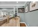 Stylish bar area features granite countertops, a sink, custom shelving, and wine storage, perfect for entertaining at 3555 Colonel Vanderhorst Cir, Mount Pleasant, SC 29466