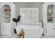 Beautiful soaking tub beneath a window and flanked by built-in shelves at 3555 Colonel Vanderhorst Cir, Mount Pleasant, SC 29466