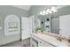 Bright bathroom featuring a modern vanity, arched window, and tiled shower with great natural light at 3555 Colonel Vanderhorst Cir, Mount Pleasant, SC 29466
