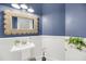 Charming powder room with a unique vanity and a round woven mirror, perfect for guests at 3555 Colonel Vanderhorst Cir, Mount Pleasant, SC 29466