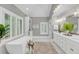 Bright bathroom with a freestanding tub, double vanity, and ample natural light from large windows at 3555 Colonel Vanderhorst Cir, Mount Pleasant, SC 29466