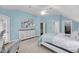 Bedroom features a light blue paint scheme, carpet, and white dresser with access to stairs and ensuite at 3555 Colonel Vanderhorst Cir, Mount Pleasant, SC 29466