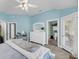Comfortable bedroom with blue walls, vaulted ceiling, and en-suite bathroom and balcony access at 3555 Colonel Vanderhorst Cir, Mount Pleasant, SC 29466