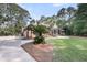 Elegant brick home with a circular driveway, lush landscaping, and a well-maintained lawn, showcasing curb appeal at 3555 Colonel Vanderhorst Cir, Mount Pleasant, SC 29466