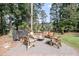 Inviting brick-paved fire pit area with comfortable wooden chairs, perfect for outdoor gatherings and relaxation at 3555 Colonel Vanderhorst Cir, Mount Pleasant, SC 29466