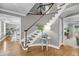 Elegant foyer with hardwood floors, curved staircase, and stylish decor at 3555 Colonel Vanderhorst Cir, Mount Pleasant, SC 29466