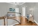 Upstairs hall with hardwood flooring, bench seat, and stylish decor with access to multiple rooms at 3555 Colonel Vanderhorst Cir, Mount Pleasant, SC 29466