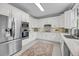 Spacious kitchen showcasing white cabinetry, stainless steel appliances, granite countertops, and a stylish backsplash at 3555 Colonel Vanderhorst Cir, Mount Pleasant, SC 29466