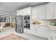 Modern kitchen with stainless steel appliances, white cabinetry, granite countertops, and an open view to the living area at 3555 Colonel Vanderhorst Cir, Mount Pleasant, SC 29466