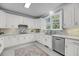 Bright and airy kitchen boasts white cabinets, stainless steel appliances, granite countertops, and a window view at 3555 Colonel Vanderhorst Cir, Mount Pleasant, SC 29466
