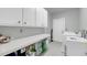 Functional laundry room with ample counter space, overhead cabinets, and modern appliances at 3555 Colonel Vanderhorst Cir, Mount Pleasant, SC 29466