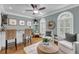 Inviting living area boasts hardwood floors, bar with seating, and arched windows for a bright and airy feel at 3555 Colonel Vanderhorst Cir, Mount Pleasant, SC 29466