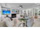 Bright living room showcases built-in shelving, a fireplace, and multiple seating areas with views to the kitchen and yard at 3555 Colonel Vanderhorst Cir, Mount Pleasant, SC 29466