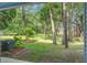 Backyard features mature trees and lush landscaping with a patio for entertaining at 4067 S Rhett Ave, North Charleston, SC 29405