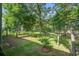 Serene backyard view from balcony featuring mature trees and lush greenery at 4067 S Rhett Ave, North Charleston, SC 29405