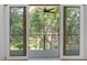 View from the balcony, showcasing lush greenery and mature trees at 4067 S Rhett Ave, North Charleston, SC 29405