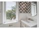 Charming bathroom featuring stylish wallpaper and a marble vanity at 4067 S Rhett Ave, North Charleston, SC 29405