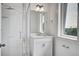 Bright bathroom featuring shower with glass door, vanity, sink and window at 4067 S Rhett Ave, North Charleston, SC 29405
