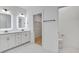 Bright bathroom featuring double vanity sinks, illuminated mirrors, and a walk-in closet at 4067 S Rhett Ave, North Charleston, SC 29405