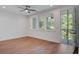 Bright and airy bedroom with hardwood floors and access to a balcony at 4067 S Rhett Ave, North Charleston, SC 29405