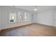Spacious bedroom features hardwood floors, a ceiling fan and natural light with backyard views at 4067 S Rhett Ave, North Charleston, SC 29405