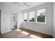 Bright bedroom with hardwood floors and large windows offering treetop views at 4067 S Rhett Ave, North Charleston, SC 29405