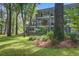 Exterior view featuring multiple balconies surrounded by lush trees at 4067 S Rhett Ave, North Charleston, SC 29405