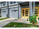 Charming townhome featuring a vibrant yellow door, garage, and well-manicured lawn at 4067 S Rhett Ave, North Charleston, SC 29405