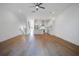 Open-concept living space features hardwood floors, white walls and an adjoining kitchen with stainless appliances at 4067 S Rhett Ave, North Charleston, SC 29405