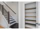 Staircase with hardwood stairs, metal railing and closet space at 4067 S Rhett Ave, North Charleston, SC 29405