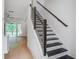 Staircase leading to the next floor, with hardwood floors in the living room at 4067 S Rhett Ave, North Charleston, SC 29405