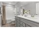 Well-lit bathroom with double sinks, grey cabinets, and shower with a tub at 470 Sanctuary Park Dr, Summerville, SC 29486