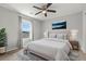 Bright bedroom with a ceiling fan, carpet flooring, blue accent rug, and a large window with great views at 470 Sanctuary Park Dr, Summerville, SC 29486