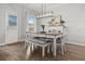 Bright dining room features a wood table, bench, chairs, and modern light fixture at 470 Sanctuary Park Dr, Summerville, SC 29486
